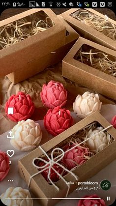 some red and white soaps in boxes on a table