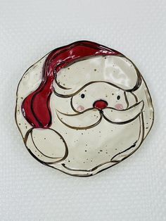 a ceramic santa claus face on a white background