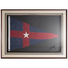 an old texas state flag hanging in a wooden frame on a gray wall with a white star