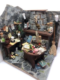 a doll house is set up in the shape of a fireplace with books and other items on it