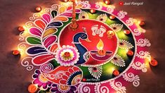 colorful rangdi design with candles on the ground