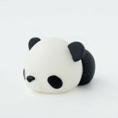 a small black and white panda bear toy