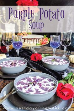 purple potato soup in a bowl on a table with wine glasses and red rose petals