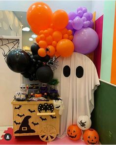 halloween decorations and balloons are on display in the hallway at this children's birthday party