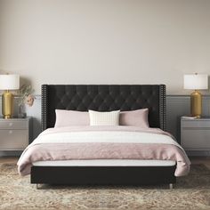 a bedroom with a large bed and two nightstands on either side of the bed