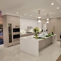 a large kitchen with an island in the middle