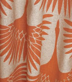 an orange and white curtain with leaves on it