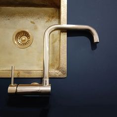 a kitchen sink that has a faucet on the side and a drain in the middle