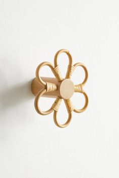 a wall mounted wooden flower on a white wall