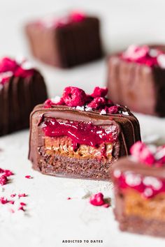 chocolate cake with raspberry toppings on white surface