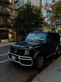 a black suv is parked on the side of the road