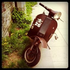 a scooter parked on the side of a road