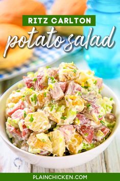 a white bowl filled with potato salad on top of a wooden table