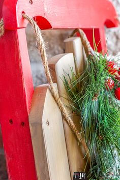 a red sleigh with christmas decorations on it