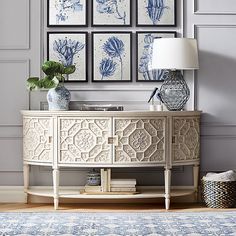 a living room with blue and white artwork on the wall