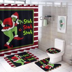 a bathroom decorated for christmas with the grin on it's shower curtain and rugs