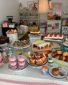 a table topped with lots of different types of cakes and pastries next to each other