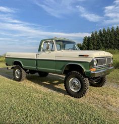 an old pick up truck parked in a field