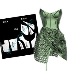 a green corset next to a black and white brochure on a white background