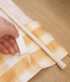 a person is cleaning the table with a cloth and two chopsticks on it