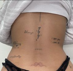 the back of a woman's stomach with writing on it