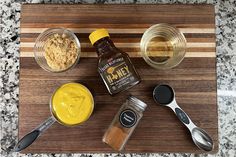 ingredients to make peanut butter on a cutting board with measuring spoons and seasonings