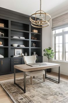 a living room with black bookcases and a white table in front of it