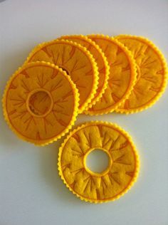 four pieces of yellow cake sitting on top of a white table