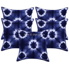 four blue and white pillows on a white background