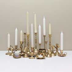 a group of candles sitting next to each other on top of a white countertop