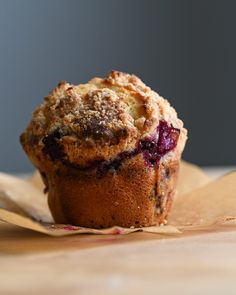 a muffin sitting on top of a piece of wax paper