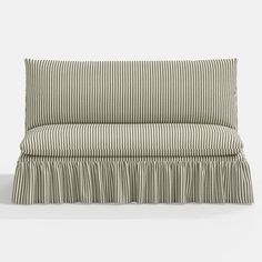 a striped pillow with ruffles on the front and back, against a white background