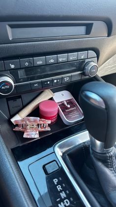 the interior of a car with various cosmetics and lipstick on it's dash board