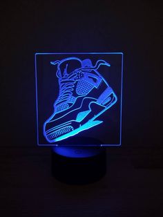 a light up sneaker is shown on a black surface with the image projected into it