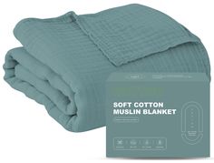 the soft cotton muslin blanket is folded up and ready to be used in bed