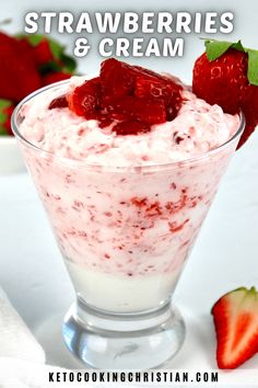 strawberries and cream in a glass bowl with two strawberries on the side next to it