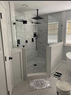 a bathroom with a walk in shower next to a bathtub and toilet bowl on the floor