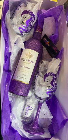 the contents of a purple gift box are wrapped in plastic