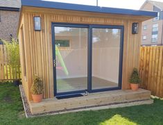 a small wooden shed with sliding glass doors