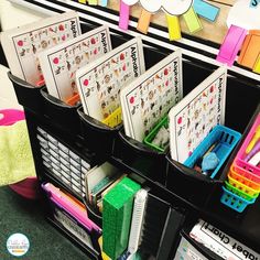 some sort of bins that are filled with different colored papers and pencils on the shelf