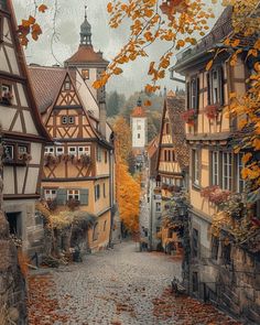 an old european village with autumn leaves on the ground