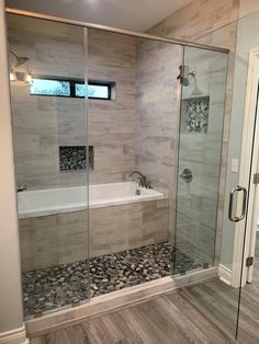 a bathroom with a walk in shower next to a bath tub