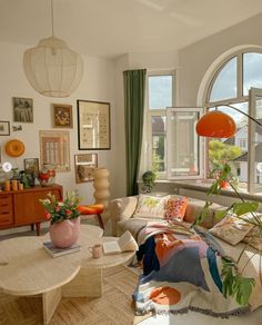 a living room filled with furniture and lots of windows next to a window sill