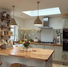 a kitchen filled with lots of counter top space and wooden stools next to an oven