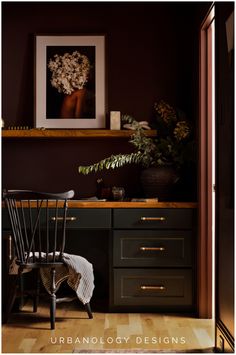 a chair sitting in front of a desk with flowers on it and a potted plant