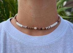 Our Canggu Necklace is one of our bestsellers! Featuring natural shells and pearl, this style is sure to be stand out on your summer adventure. Wear this on your casual day or dress it up for a signature beachy feel.  Freshwater pearl Puka Shells  Coconut Shell Wood Wax Cord approx 16" with adjustable 7" knot - adjustable and waterproof! Matching bracelet and anklet!   Mix and match with your favorite HALT pieces or wear alone for boho beach vibes. The perfect gift for him or her. Our jewelry is handmade in the Sunshine State with local materials and shipped with an effort to use environmentally friendly packaging, making it the perfect choice for those who shop with a green mindset. Puka Shell Necklace Outfit, Beachy Bracelets, Puka Shell Necklace, Necklace Outfit, Vacation Accessories, Wood Wax, Puka Shell, Matching Bracelet, Perfect Gift For Him