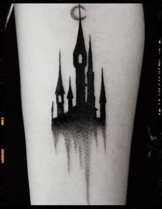 a black and white photo of a castle tattoo