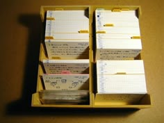 several yellow boxes with papers in them sitting on a table