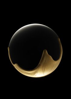 a black and gold object is shown in the dark