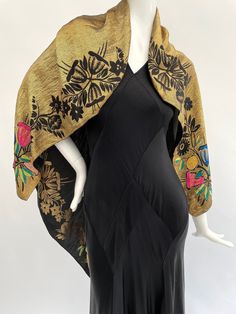 "This vibrant antique 1920s to 1930s lamé shawl or scarf is made from metallic threads in a gold colour with stylised floral details in shades of pink, blue, yellow, green and black. This can be worn on both sides (you can see it worn each way in the photos). This is a versatile piece that can be worn folded or unfolded in a variety of different ways.  It is a smaller size, measuring approximately 40\" inches by 38\" inches, please check that the size will meet your needs before you purchase.  The condition is good overall with some areas of darkening to the gold metallic threads in places, this is to be expected with a shawl of this age. This is most noticeable in a section on the gold side of the shawl (it is visible on the black side but less so), and along the fold lines on the gold si Victorian Shawl, Cape Fashion, Pink Blue Yellow, Vintage Gowns, Vintage Mode, Shawl Scarf, Black Side, Gold Colour, Shades Of Pink